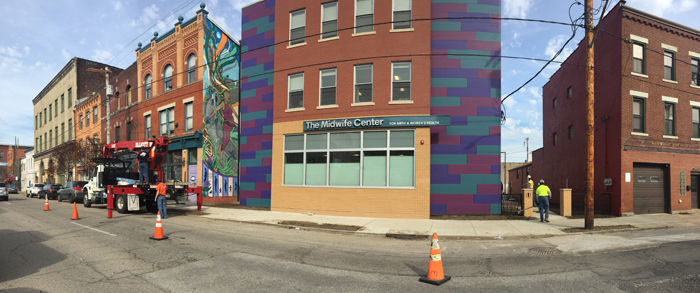 A bright, sunny day, showing Penn Avenue in the Strip District and the front of The Midwife Center's expanded building.