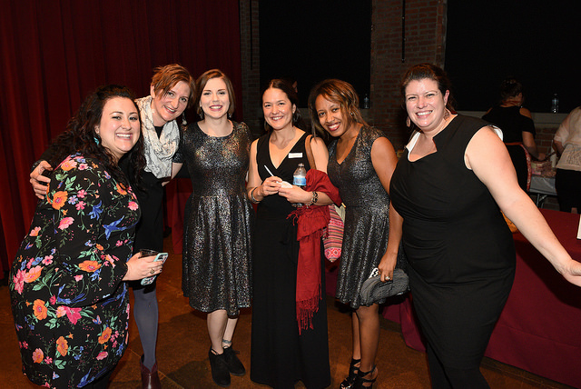 Photo of event guests smiling.