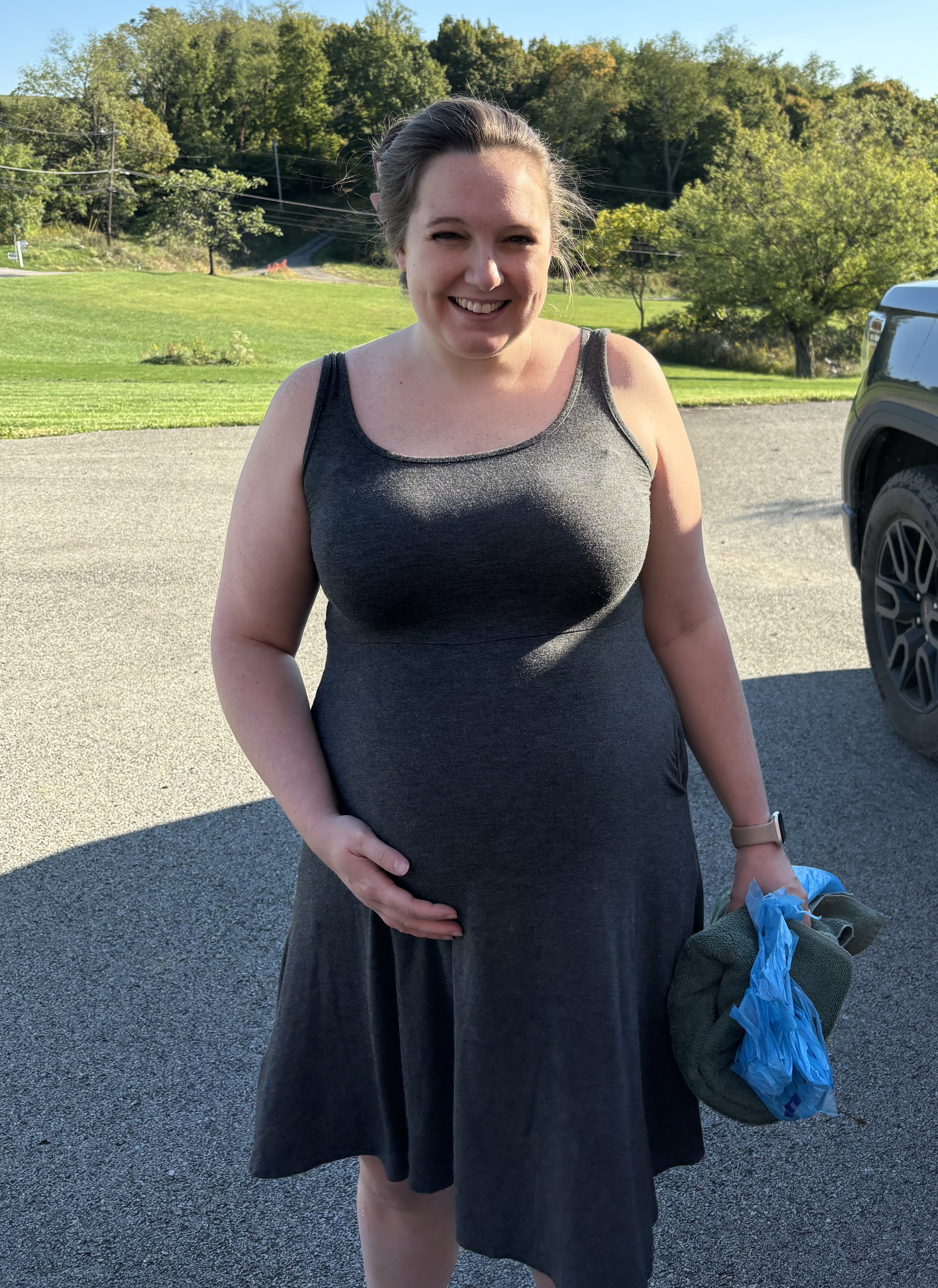 Carissa poses for a photo before making her way to The Midwife Center in labor. She has a towel in her hand in case her water broke and a bag in case she got sick.